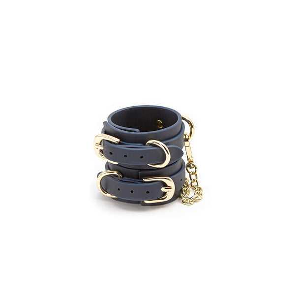 Bondage Couture navy blue vegan leather wrist cuffs with gold-tone buckles and chain connector