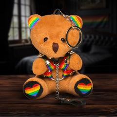 XR Pride Teddy Bear Keychain with Rainbow Harness – small tan plush bear with rainbow harness and black spiked collar