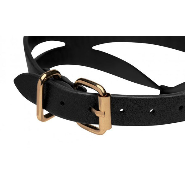 Close-up of adjustable gold-tone buckle and punch holes on black faux-leather collar strap