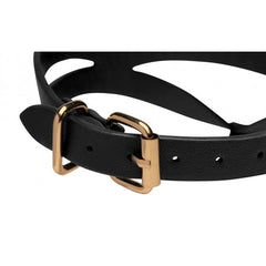 Close-up of adjustable gold-tone buckle and punch holes on black faux-leather collar strap