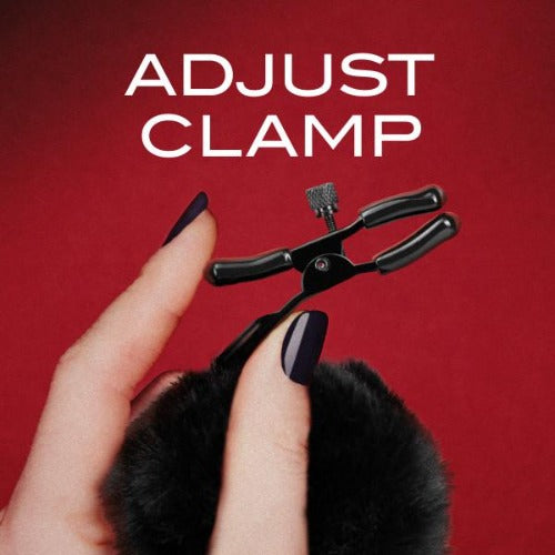 Close-up of adjustable screw clamp mechanism on Noir Pom Nipple Clamp held by manicured hand