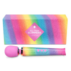 All That Glimmers by Le Wand wand massager beside its rainbow glitter packaging box
