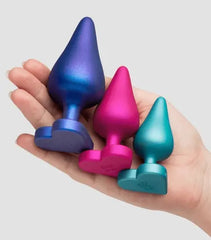 All three ROMP Luster silicone anal plugs held in one palm to illustrate size progression