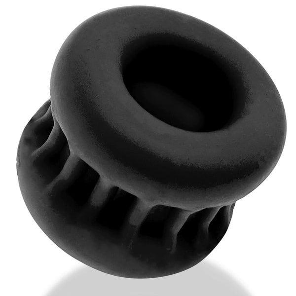 Angled view of black Oxballs CORE ballstretcher showing hourglass shape and top opening
