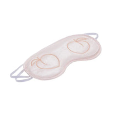 Close-up angled view of embroidered peach motifs on soft padded blush satin blindfold