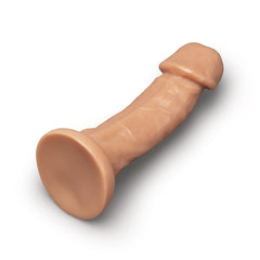 Angled lay-flat view of realistic dildo displaying strong suction-cup base and full shaft length