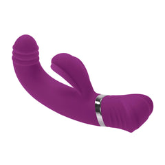 Angled view of purple dual-stimulation vibrator lying flat highlighting curved shaft and clitoral arm