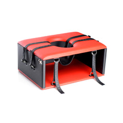 Angled view of the Queening Chair highlighting padded red top, oval opening, and D-ring anchor points