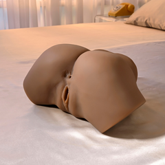 Angled rear view of mocha stroker lying flat on bed, showing natural contoured form