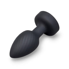 Angled view of ribbed black silicone plug body with flared base and charge port