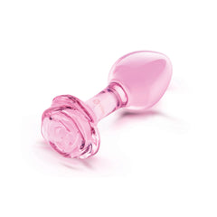 Angled side view of a pink glass rose plug showing smooth bulb and sculpted flower base