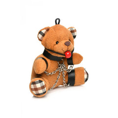 Angled side view of plush bear keychain highlighting plaid paw pads and black strap detailing
