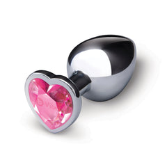Angled view of silver metal butt plug with pink heart crystal base on white background