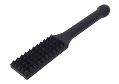 Angled close-up of spiked silicone paddle showing raised pyramid studs across the paddle surface