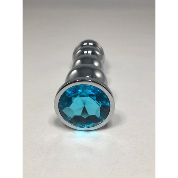 Close-up of the aqua blue faceted crystal base on the silver beaded metal anal plug