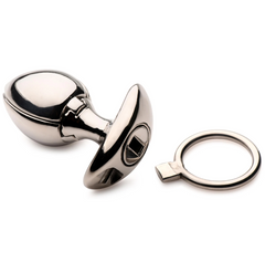Ass Vault anal plug in closed position beside its steel ring lock tool, mirror-polished surface