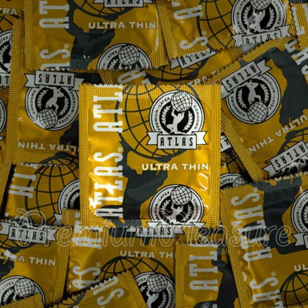 Atlas Ultra Thin condoms bulk pile, gold foil square packets with globe logo