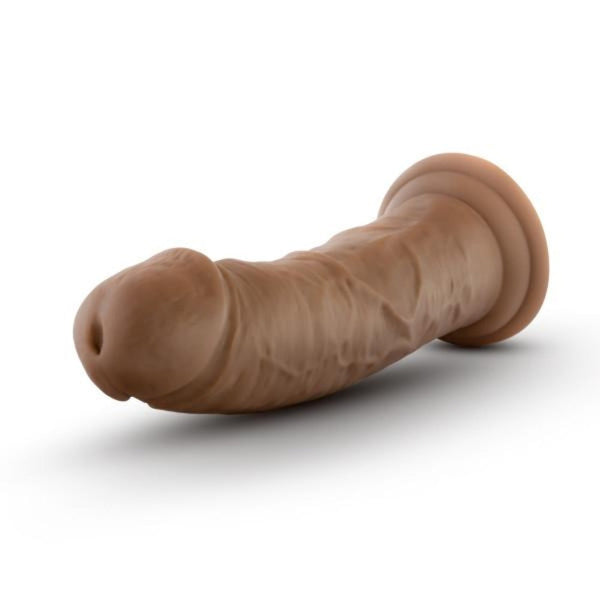 Au Naturel mocha dildo shown horizontally, highlighting realistic texture and suction base