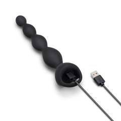 b-Vibe 6.5" Vibing Beads connected to USB magnetic charging cable, showing charging setup