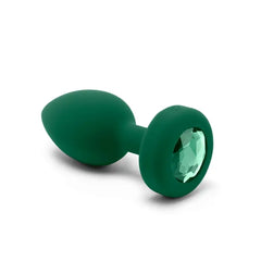 Close-up of b-Vibe jewel plug base featuring a faceted emerald green crystal