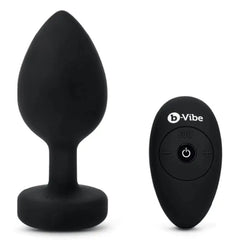 b-Vibe Jewel Plug XXL black silicone plug shown beside its wireless remote control