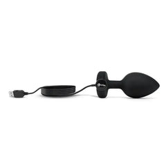 b-Vibe Jewel Plug XXL connected to USB magnetic charging cable for recharging