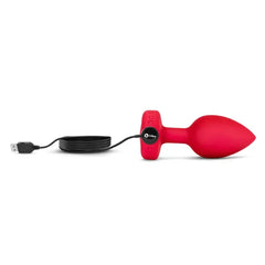 b-Vibe plug connected to black USB magnetic charging cable, side profile view