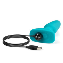 b-Vibe plug lying on side connected to magnetic USB charging cable