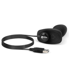b-Vibe Rimming Plug Petite connected to USB magnetic charging cable