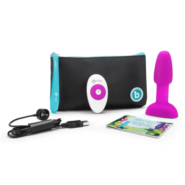 b-Vibe Rimming Plug Petite in fuchsia silicone shown with remote, USB cable, pouch, and guide