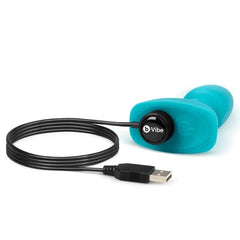 b-Vibe Rimming Plug Petite teal silicone plug connected to magnetic USB charging cable