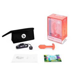 b-Vibe Snug Plug 1 displayed with included storage pouch, USB charger, and user guides