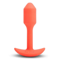 b-Vibe Snug Plug 1 front view showing tapered tip and curved anchor base in coral silicone