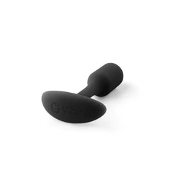B-Vibe Snug Plug 1 lying on its side showing smooth base with embossed brand logo