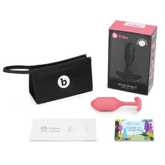 b-Vibe Snug Plug 2 unboxed with storage pouch, guides, and coral plug displayed
