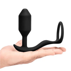 b-Vibe Snug & Tug weighted plug with cock ring resting on an open palm showing overall size