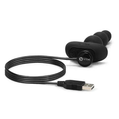 b-Vibe Triplet Anal Beads in black silicone connected to magnetic USB charging cable