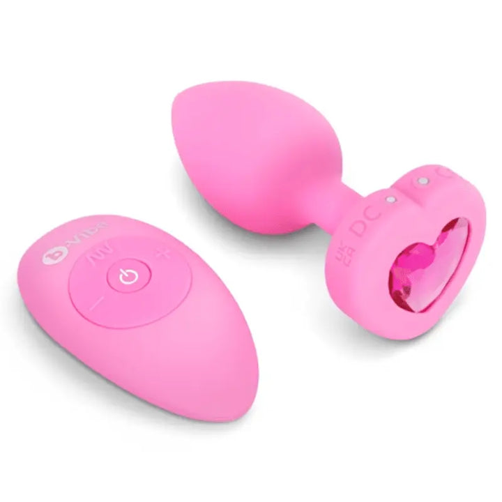 b-Vibe Vibrating Heart anal plug in pink silicone shown with wireless remote control
