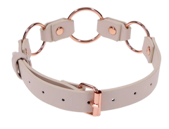 Back view of cream faux leather day collar displaying rose gold buckle closure and three O-rings