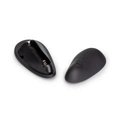 Back panel of b-Vibe remote open showing battery compartment alongside closed remote