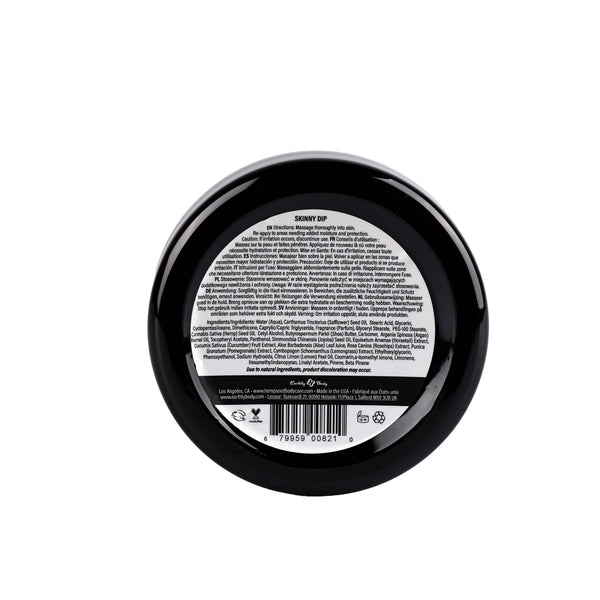 Back view of Skinny Dip skin butter jar displaying usage instructions and barcode on black lid