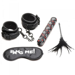Bang! Bondage Kit flat lay: wrist cuffs, blindfold, XL bullet vibrator, and feather tickler