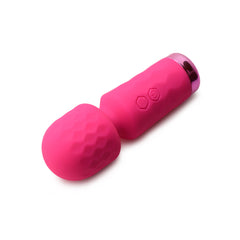 Bang mini silicone wand lying on side, showing diamond-textured head and metallic base ring