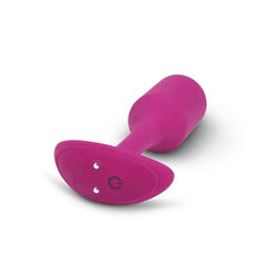 Base of fuchsia snug plug showing charging contacts and b-Vibe logo detail