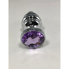 Base view of silver ribbed anal plug showing faceted oval purple crystal set in smooth chrome bezel