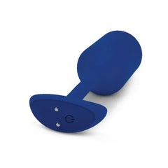 Base of vibrating plug showing magnetic charging points and single control button
