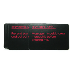 Close-up of Bedroom Commands black game cards fanned out showing bold pink printed text