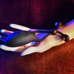 The Big Bang black silicone cock ring resting in an open hand showing flexible lasso straps