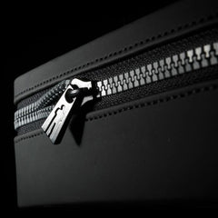 Close-up of black dual-zipper closure on the Male Edge Extra hard-shell carry case