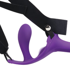 Close-up of black elastic harness O-ring attachment point securing the purple silicone dildo in place